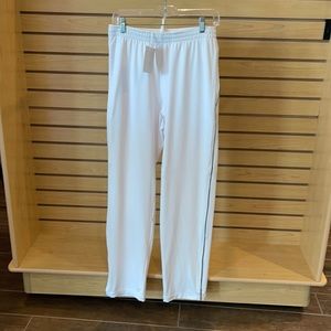 Green Grass tennis warm up pants. White with a navy pinstripe down the legs.